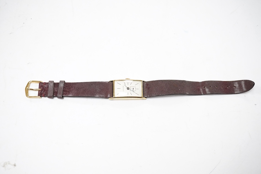 A gentleman's 14k gold Longines manual wind wrist watch, with rectangular dial, baton numerals and subsidiary seconds, case diameter 20mm, on a later associated strap. Condition - fair